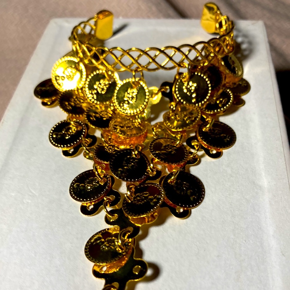 Gold tone Indian coin bracelet with attached ring.  Adjustable. Bme2134